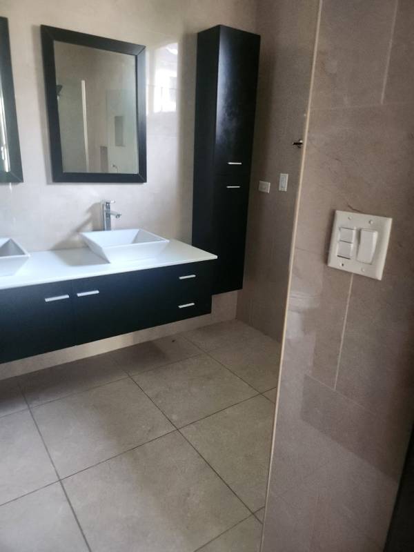 Luxury bathroom with floating vanity, vessel sinks, wall mirrors Senderos de Camino de Cruces