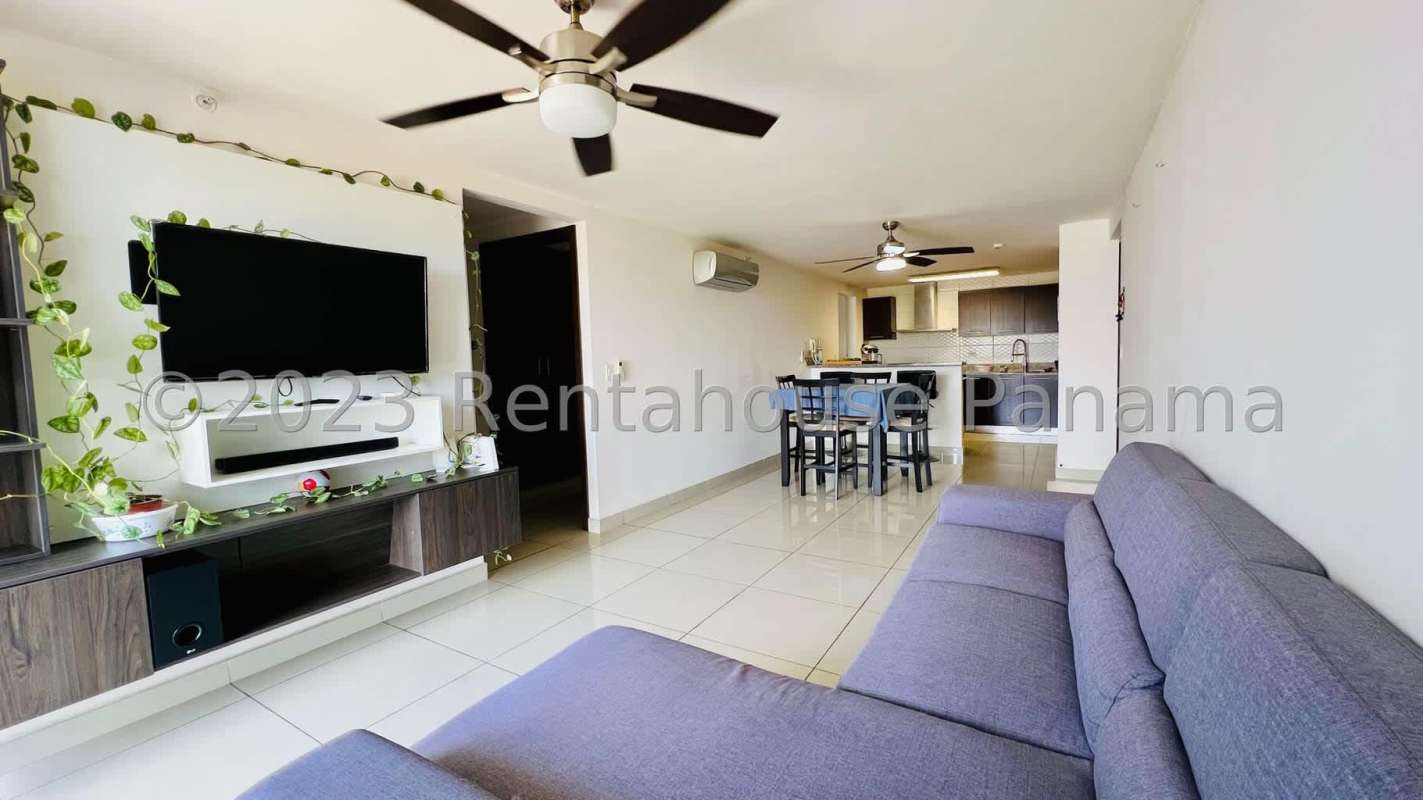 Bright living and dining area with porcelain tile and balcony at Condado Country Club Panama