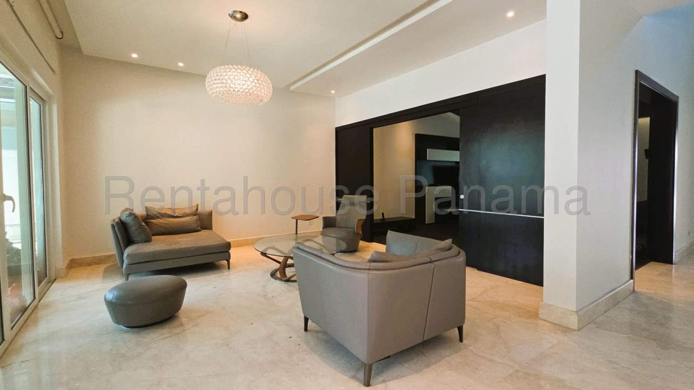 Spacious modern living room with marble floor and large windows at luxury Costa del Este home Panama City