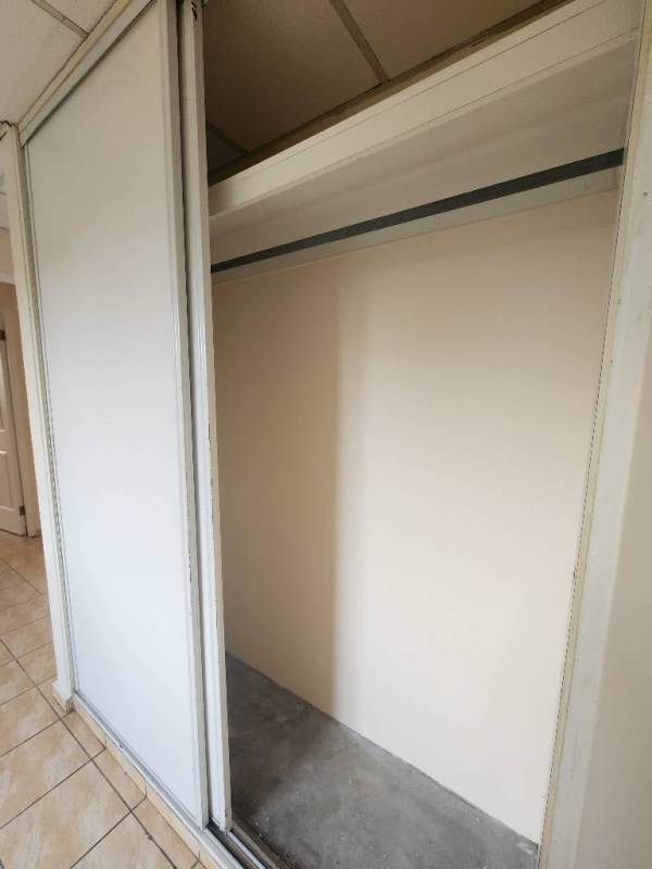 Bedroom with window, closet and tile floor at PH Altos de la Primavera Villa Lucre Panama