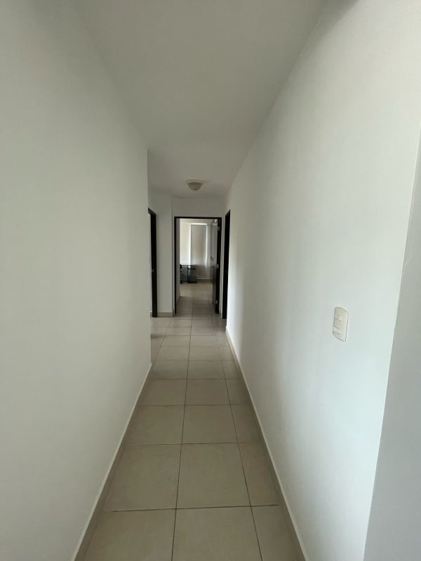 Long tiled hallway connecting bedrooms and living room in apartment at PH Clayton Park