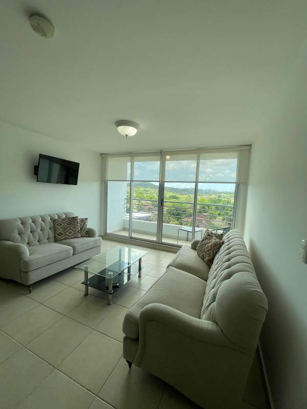 Spacious furnished living room with large glass doors opening to balcony at PH Clayton Park