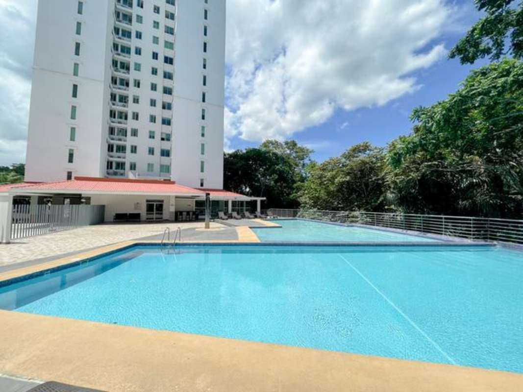 Large outdoor swimming pool with lounge area at PH Clayton Park Panama City