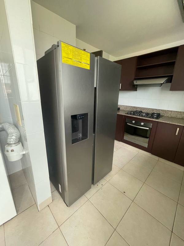 Kitchen with granite countertop, stainless refrigerator, cabinets at PH Clayton Park Tower Panama