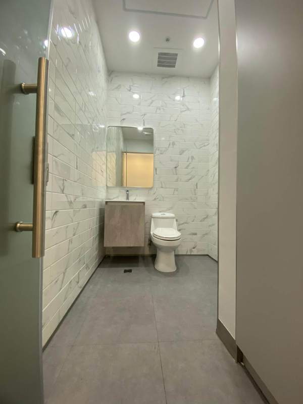 Modern built-in cabinet with multiple shelves and window view Town Center Costa del Este medical office