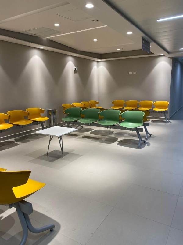 Modern medical waiting area with yellow and green chairs tiled floors Town Center Costa del Este