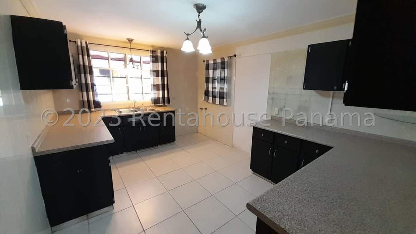 Kitchen with granite countertops, cabinets, tiled floor, and window in El Bosque Panama house