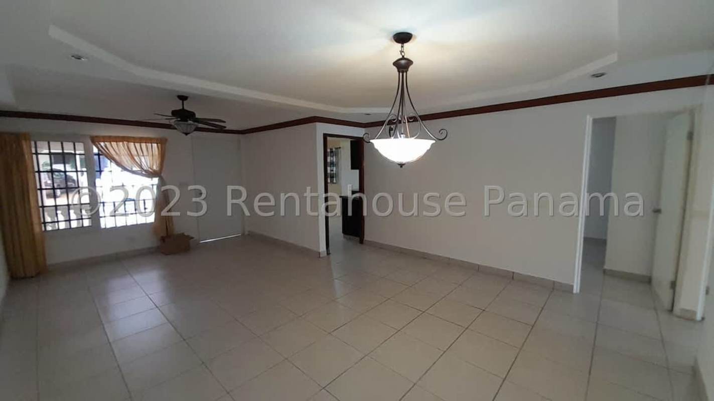 Covered carport with white columns and terracotta tiles at El Bosque Condado del Rey Panama house