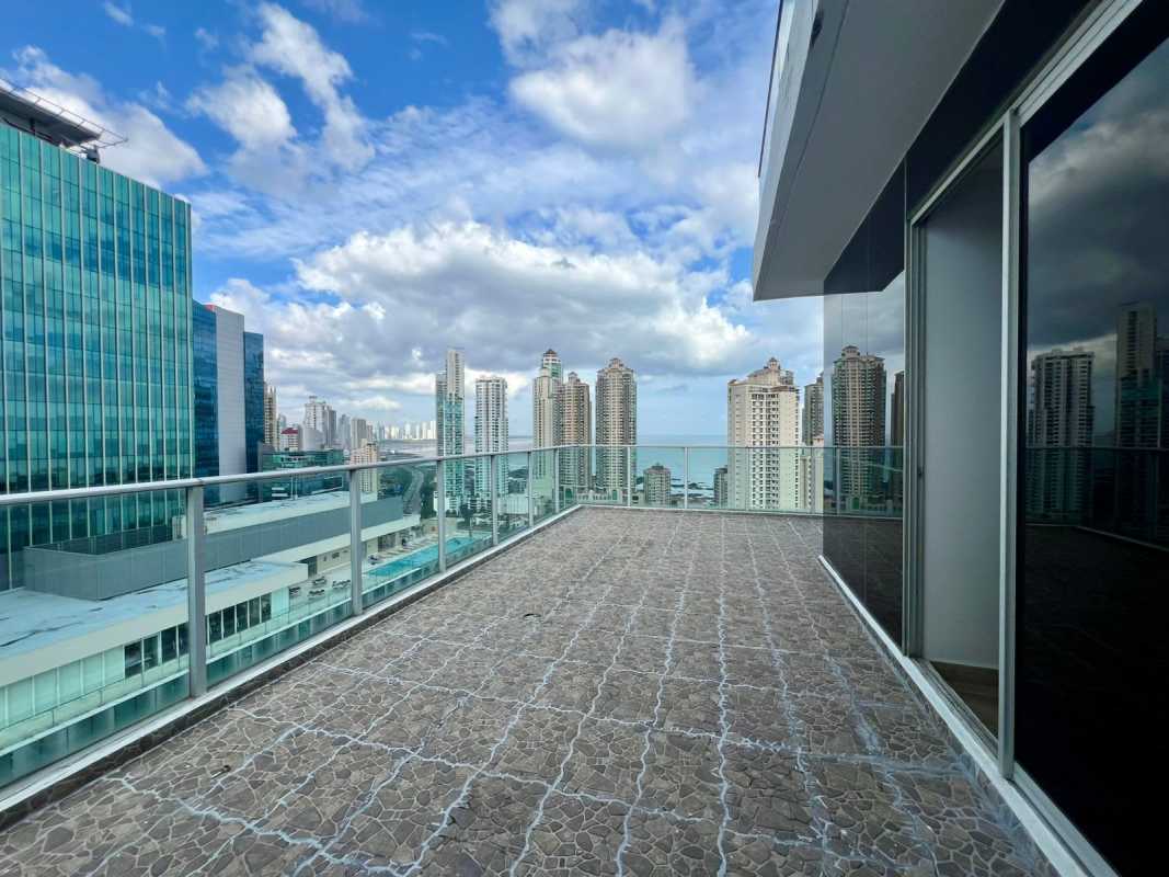 Bright living area with tile floor and wide windows overlooking ocean and skyline in Punta Paitilla Panama
