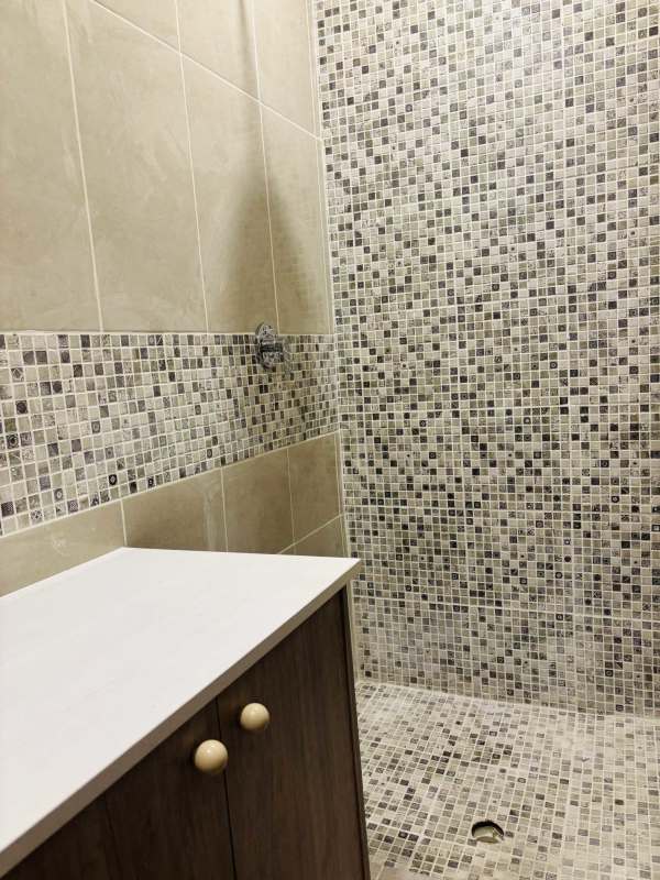 Remodeled bathroom with walk-in shower and modern fixtures in Panama City house