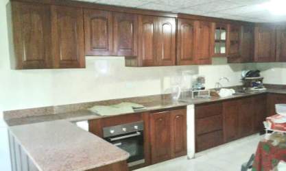 Dining area with kitchen cabinetry and granite counter in Vista Alegre, Panama