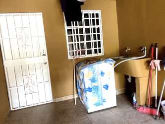 Exterior gated parking space and house facade in Villa Karla, Arraiján