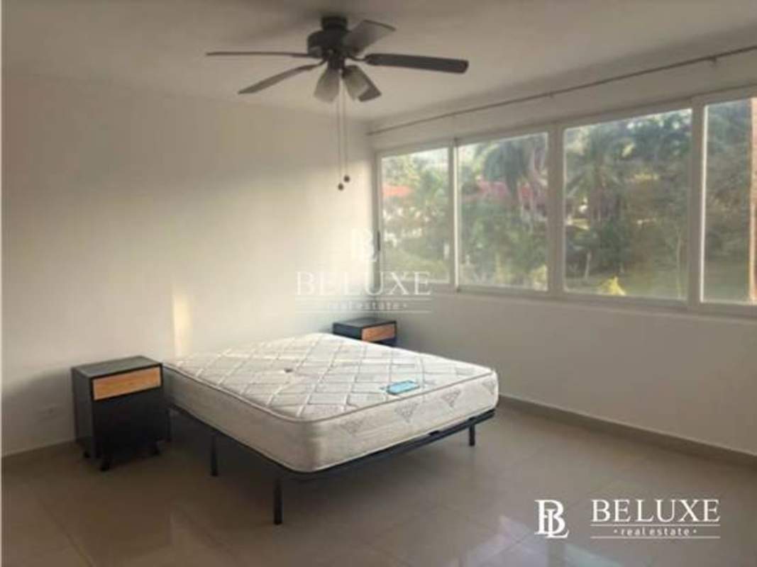 Master bedroom with large window, built-in closet, tile flooring in PH Sun City Albrook Panama