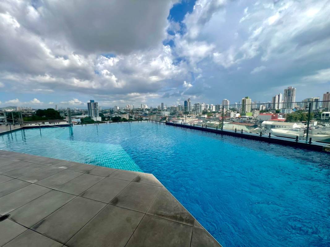 Modern kitchen with breakfast bar, wood cabinets in PH Vivendi Green Edison Park Panama City apartment for sale