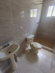 Minimalist tiled bathroom with walk-in shower Costa Oeste rental Panama