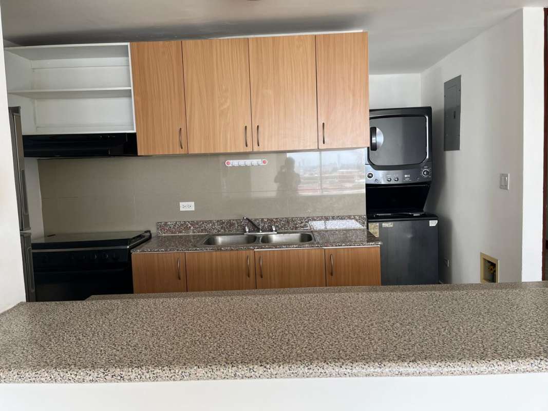 Modern kitchen with granite-look countertops, refrigerator, stove, PH Central Park Hato Pintado Panama