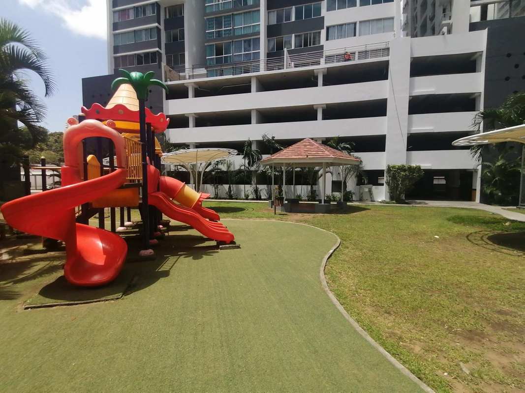 Outdoor kids playground with gazebo in front of high rise tower PH Central Park 12 Octubre Panama