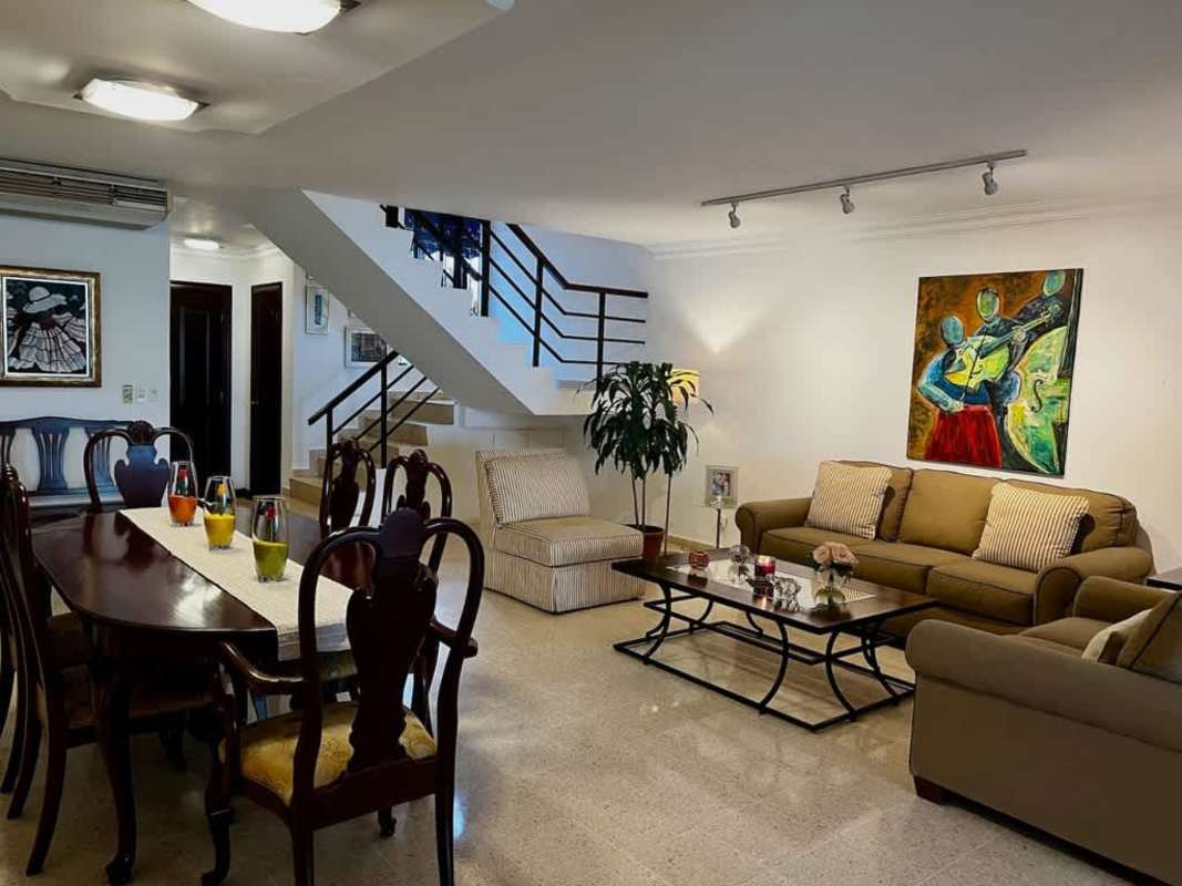 Contemporary spacious living and dining area with staircase and art in Los Flamingos San Francisco Panama