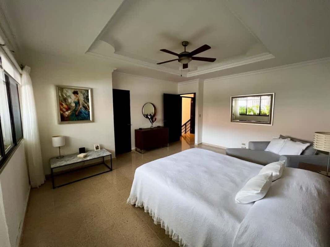 Master bedroom with tray ceiling, large windows, sofa, wall art in Residencial Los Flamingos San Francisco