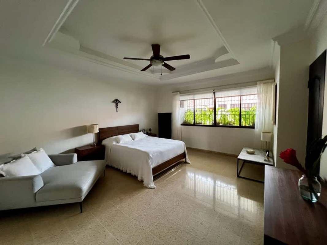 Bedroom with large windows, tray ceiling, and tile flooring at Los Flamingos San Francisco Panama