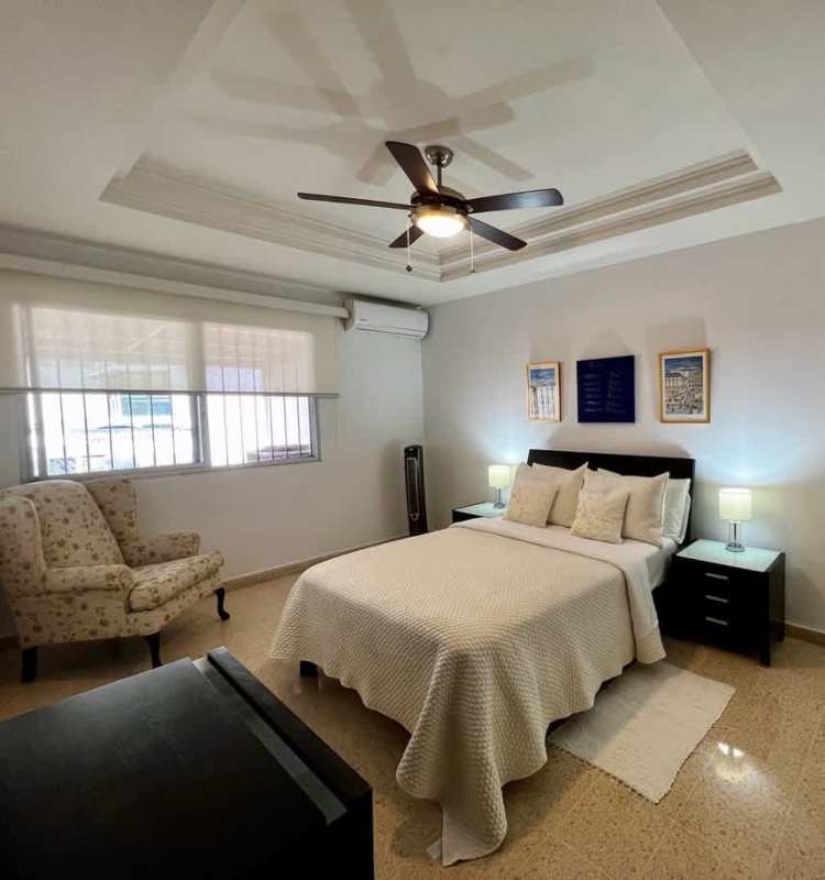 Master bedroom with tray ceiling, ceiling fan, large window, queen bed at Residencial Los Flamingos San Francisco Panama