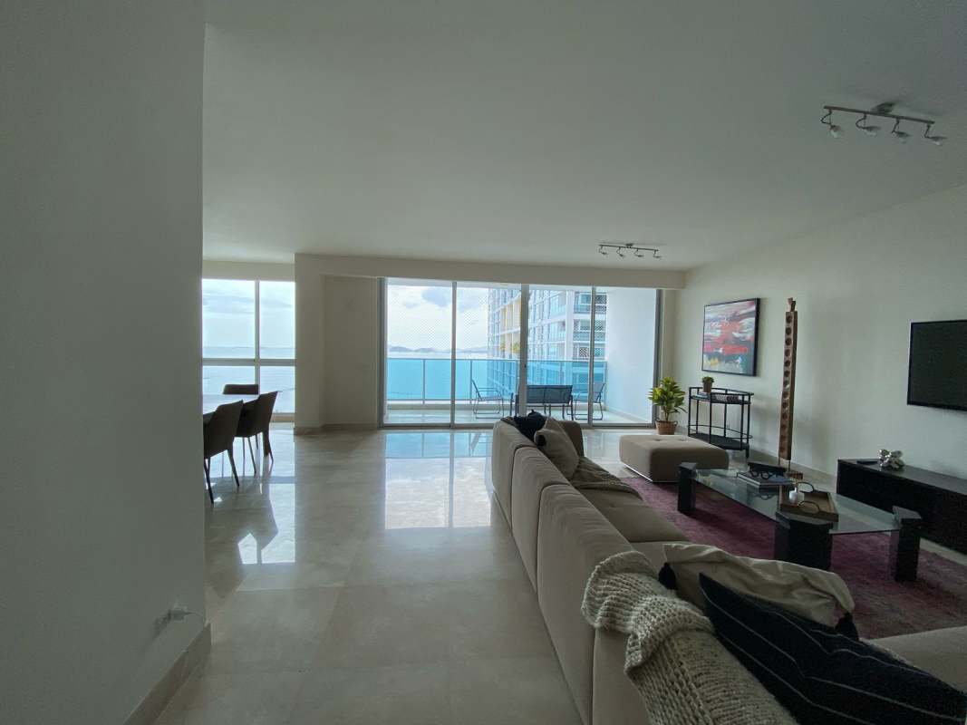 Open-plan living and dining area with ocean view balcony PH BICSA Tower Panama City