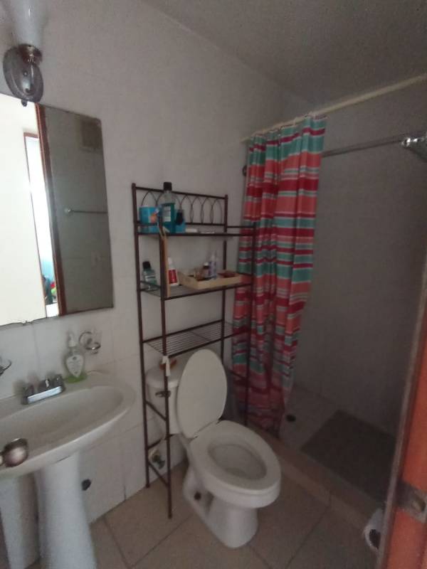 Bathroom with walk-in shower, pedestal sink, and tile in PH Central Park Tower Broadway
