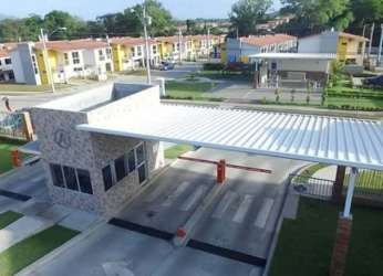 Drone aerial of gated residential complex Residencial Santillana with entrance and amenities