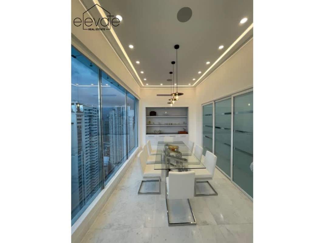 Floating spiral staircase inside luxury penthouse PH Venetian with ocean backdrop Panama City Panama