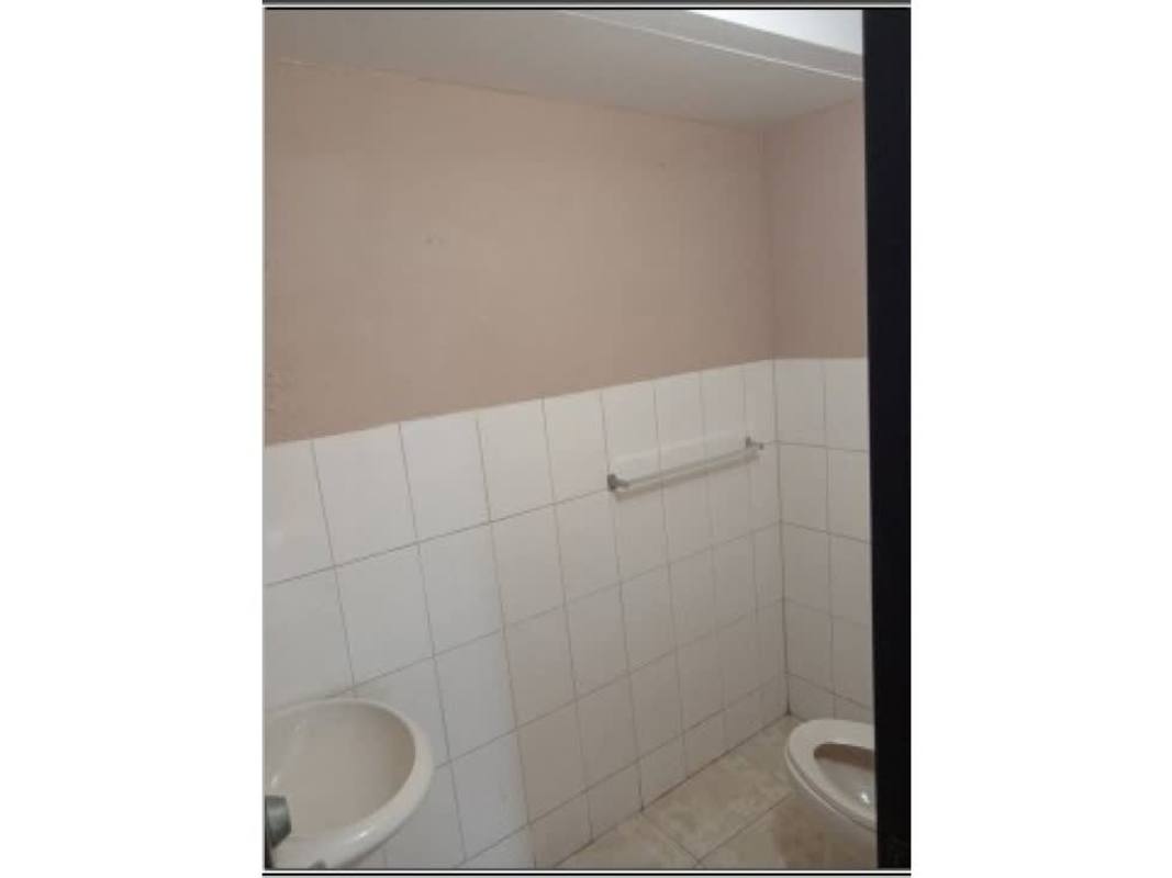 Contemporary bathroom with glass-enclosed shower, beige tiles, sink in Brisas del Golf Panama