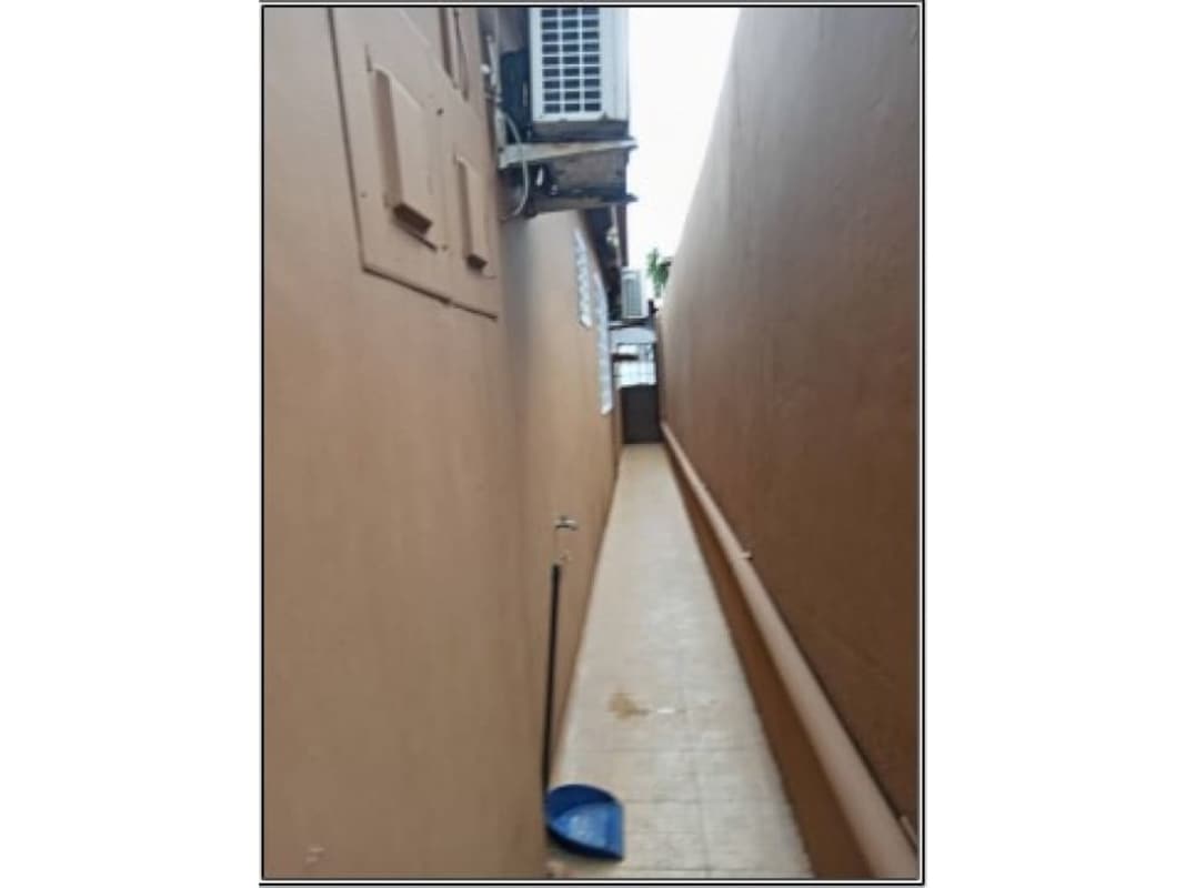 Tiled patio with grill, AC unit, fenced yard in Brisas del Golf house Panama City