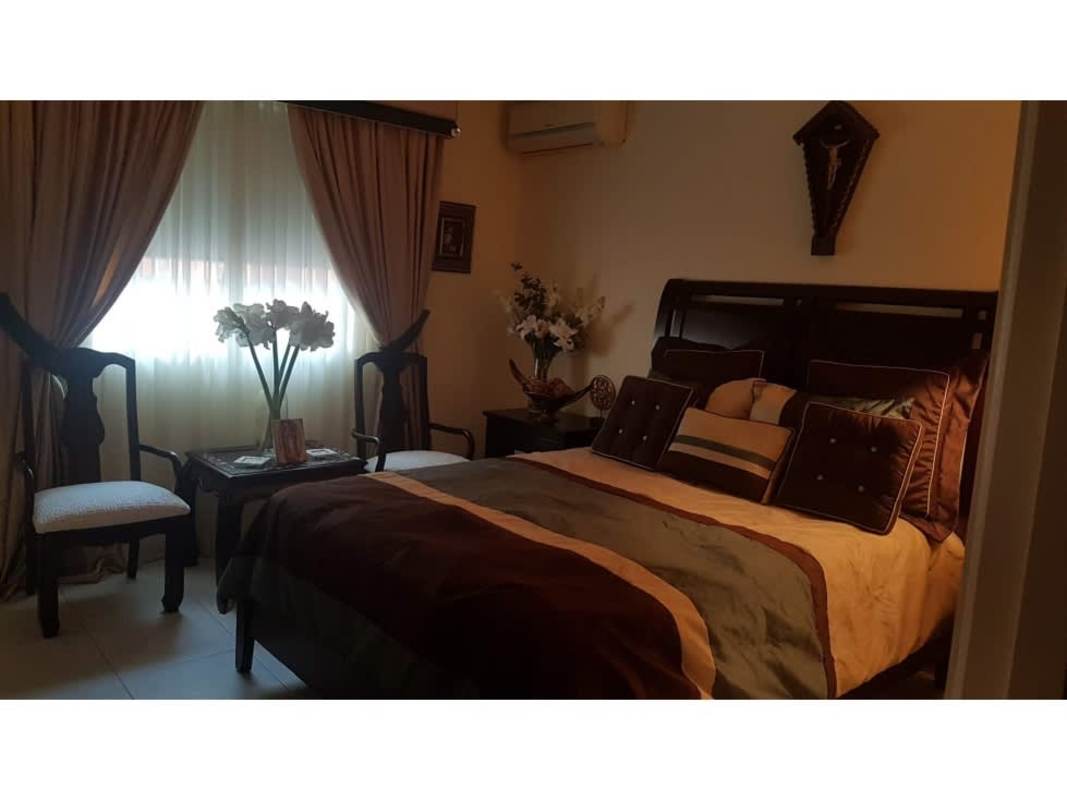 Spacious covered patio with built-in bar perfect for entertainment in remodeled El Bosque house Panama