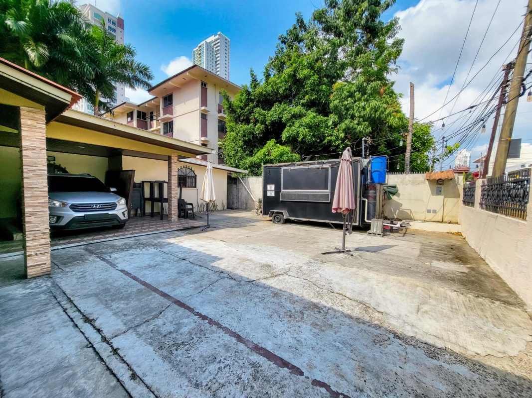 Gated driveway and covered carport with seating and stone pillars, Coco del Mar