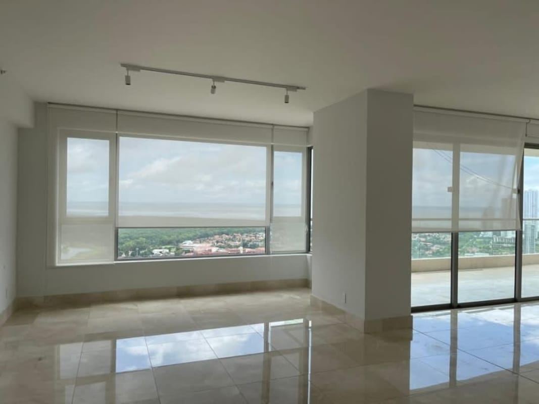 Spacious living room with marble flooring and large windows in luxury Panama condo