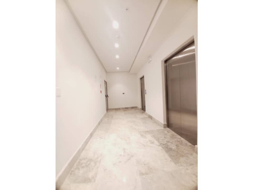 Bright hallway with elevators and marble floors at Empire Residences Santa Maria Panama