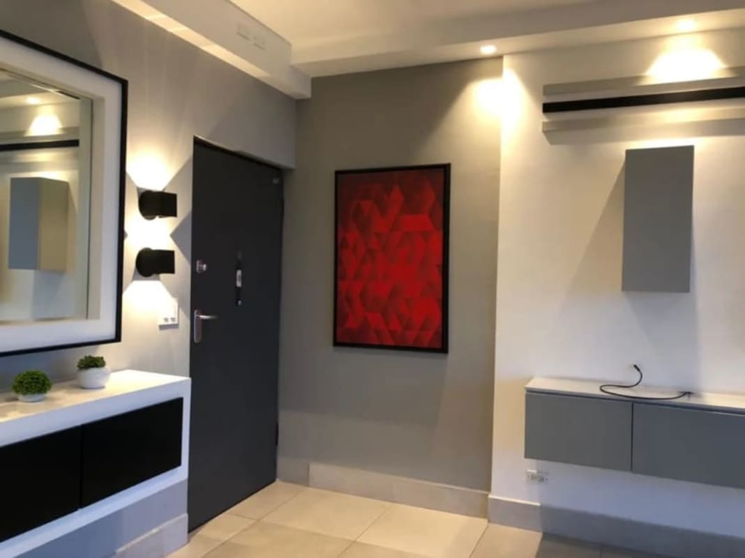 Modern kitchen with cabinetry and view into laundry PH Dos Mares Betania Panama