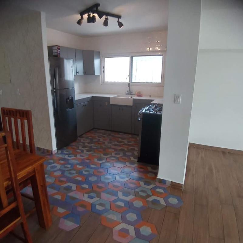 Corner kitchen with gray cabinets colorful hexagonal floor tiles PH Sandra La Cresta Panama