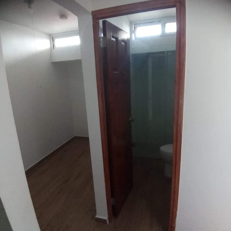 Minimalist small bedroom with en-suite bath vertical windows PH Sandra Panama City