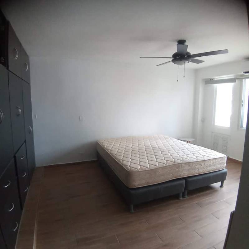 Bedroom with ceiling fan, large window, built-in closet wood floors PH Sandra La Cresta Panama
