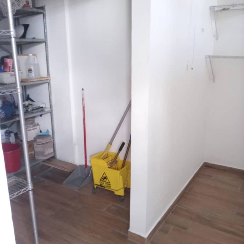 Storage utility room with shelving, cleaning supplies, mop bucket in PH Sandra Bella Vista Panama