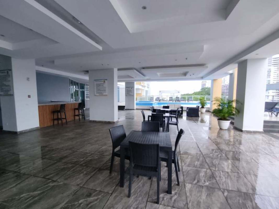 Covered outdoor terrace lounge with dining and bar near swimming pool at PH Residencias del Sol Panama City