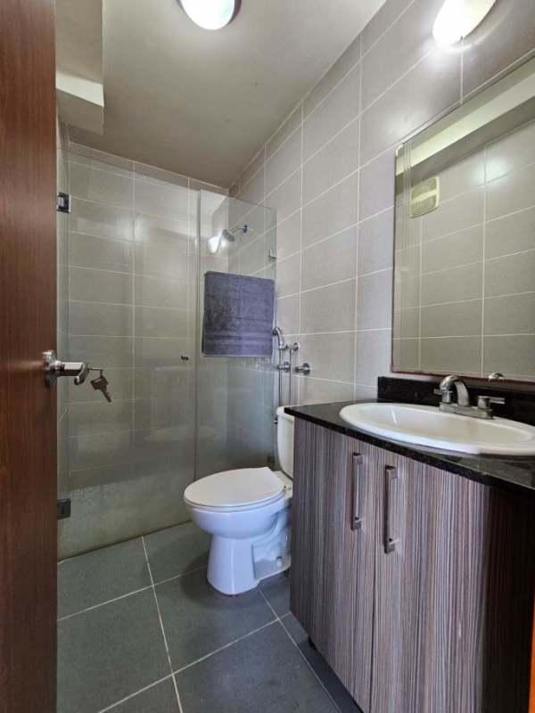 Modern bathroom with glass shower and tiled walls PH Residencias del Sol Panama