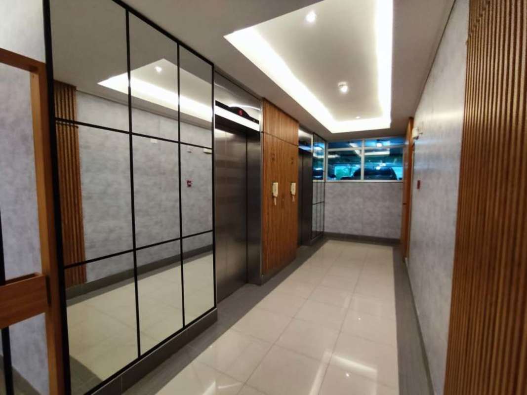 Modern galley kitchen with cabinetry and granite counters PH Residencias del Sol Panama