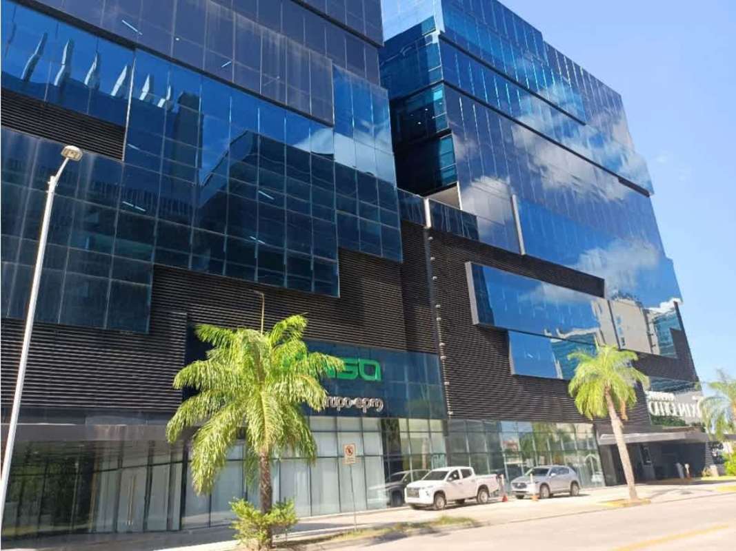 Glass facade office building in Santa María Business District with palm landscaping