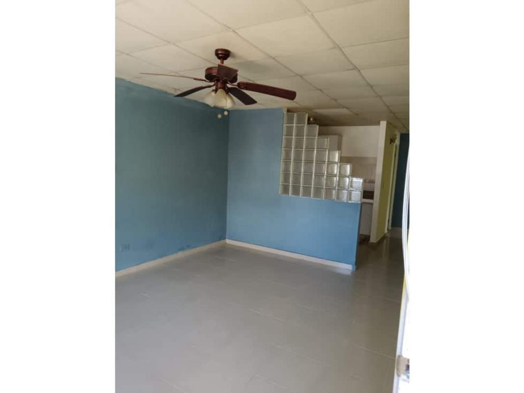 Living room with ceiling fan blue walls glass block divider for sale Pradera de San Lorenzo Panama