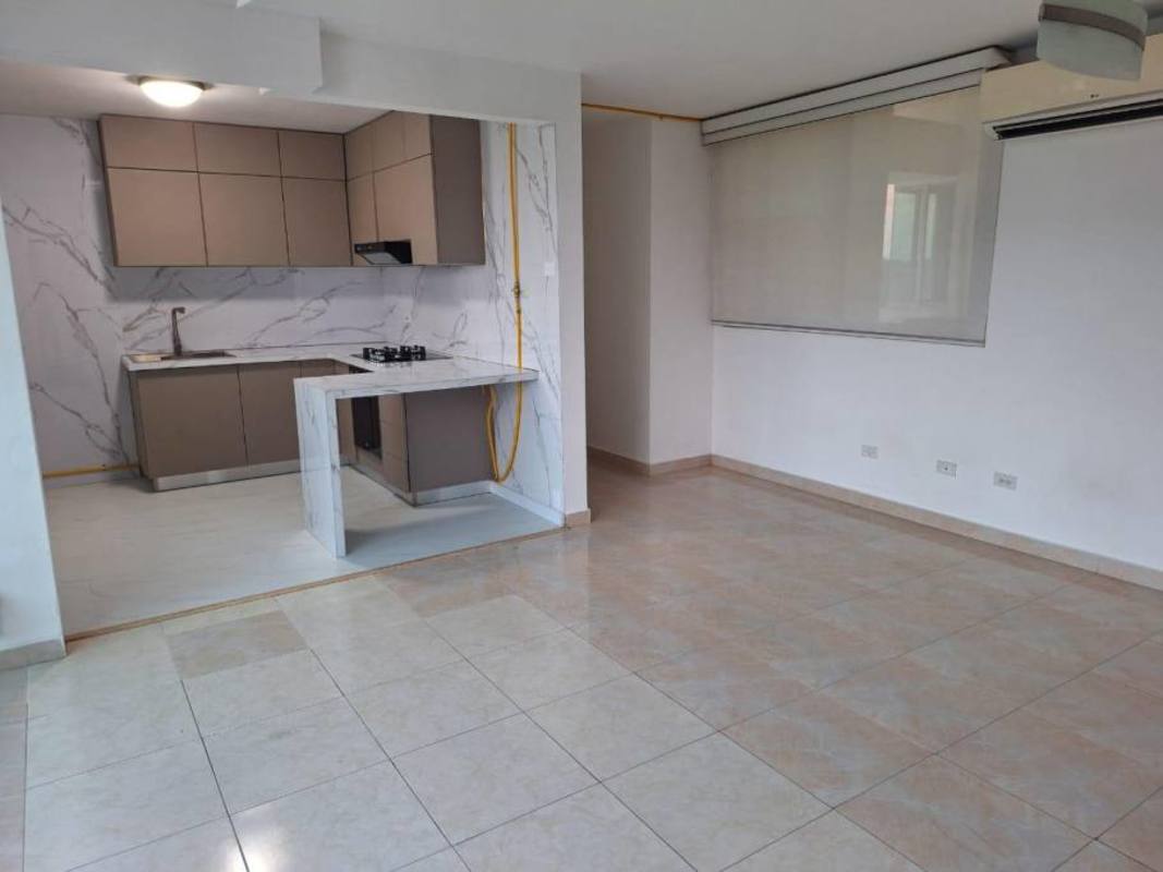 Open-plan living with kitchen, tiled floors, large window at PH Elmare Plaza Edison Panama