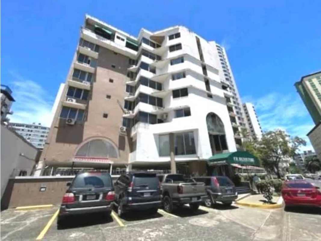 Facade of PH Hilton Park with ground-floor commercial spaces, parking and AC units in Bella Vista Panama