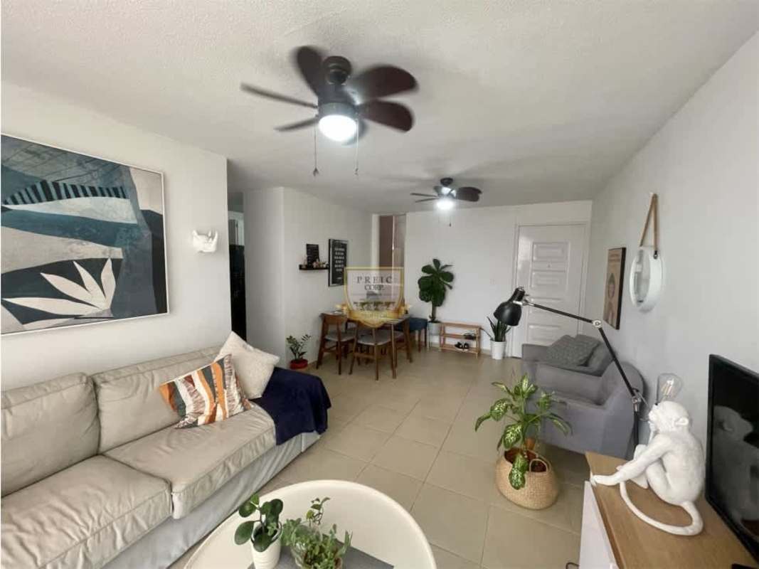 Bright open concept living and dining room with tiled floors in PH Mystic Village Panama City