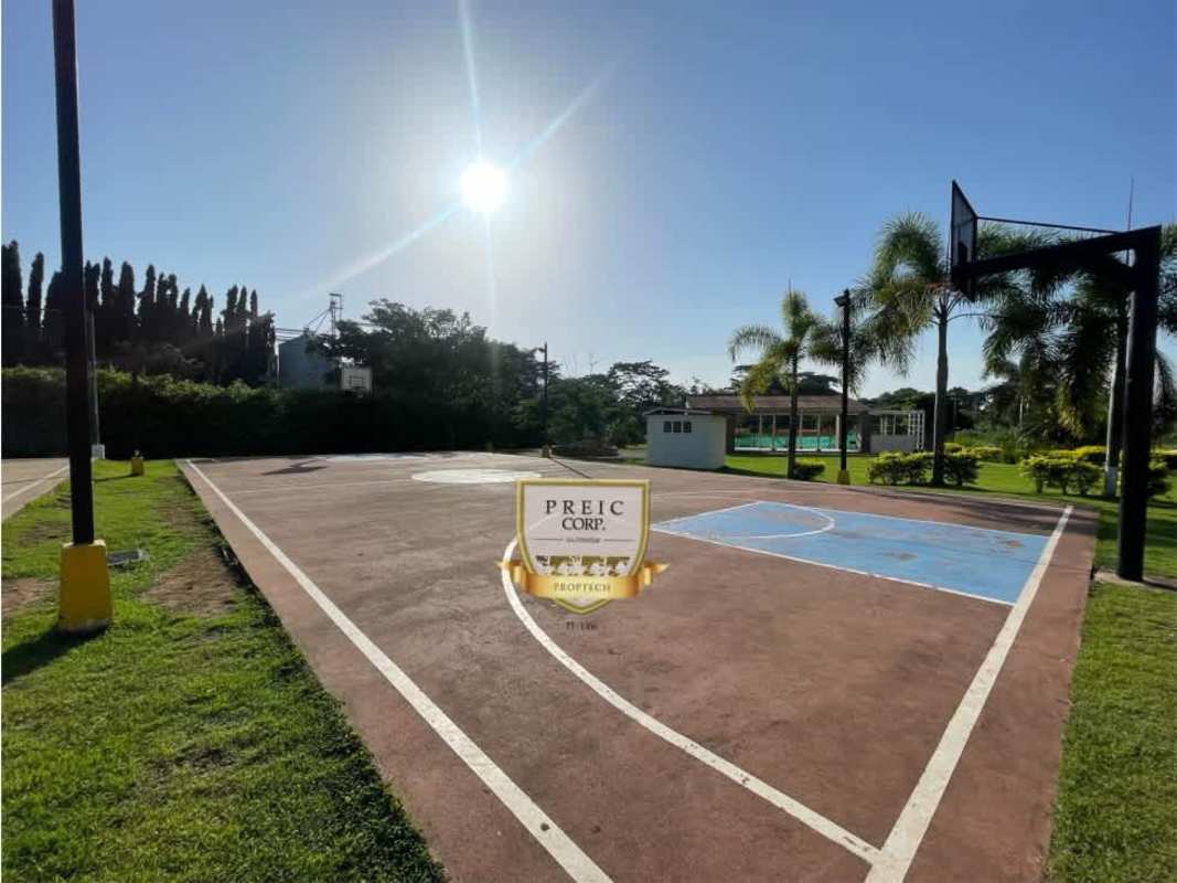 Galley-style kitchen with granite counters and refrigerator at PH Mystic Village Panama City