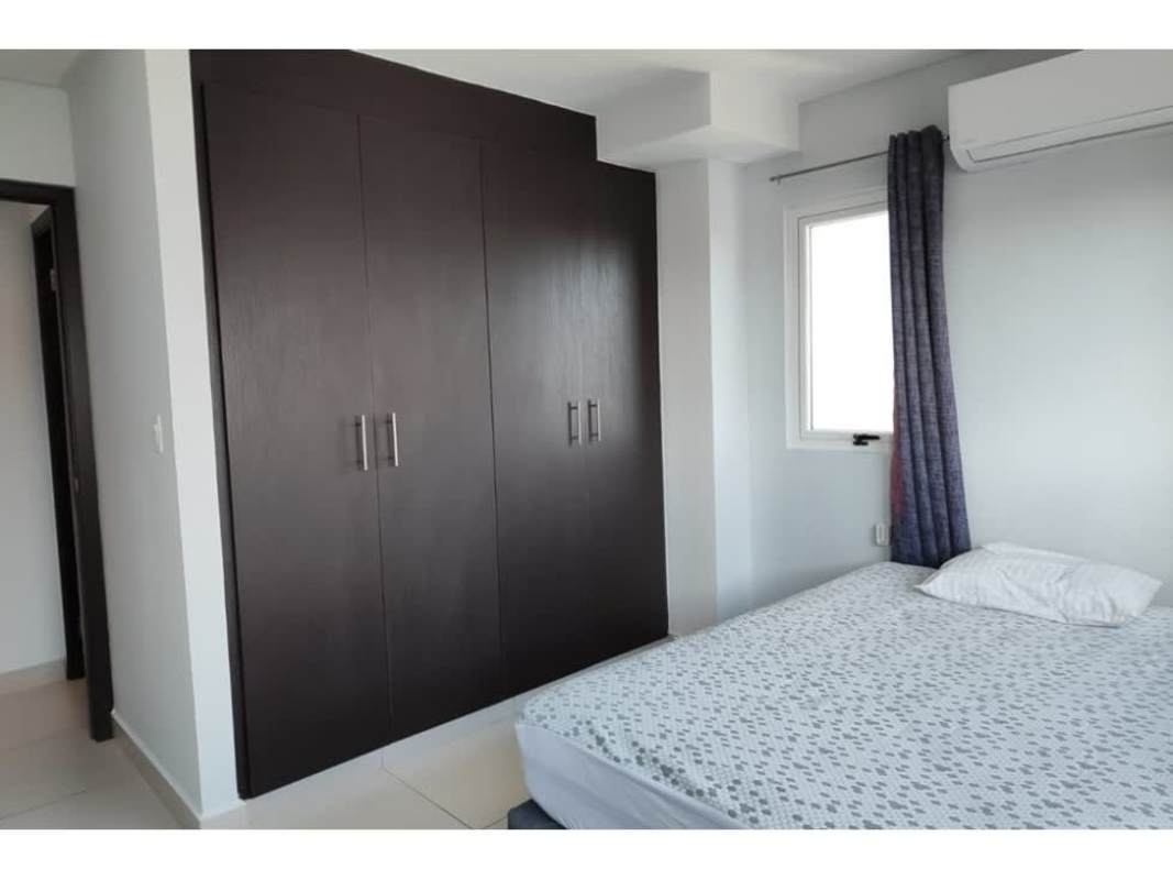 Bathroom with glass shower, beige tiled walls and white fixtures PH Tee One apartment Panama
